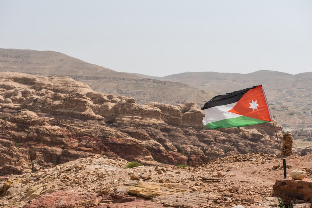 The flag of Jordan blowing in the wind in Petra, Jordan